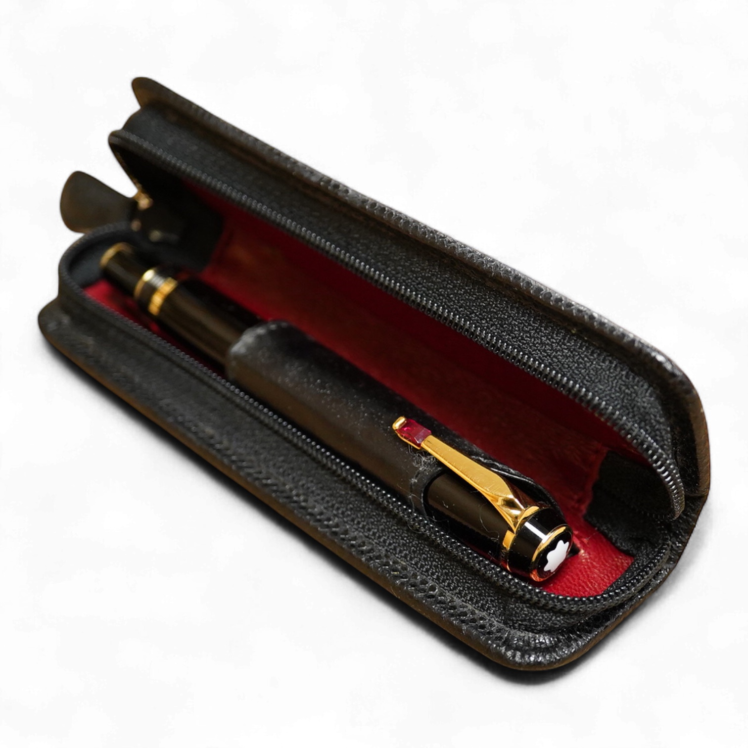 A leather cased Mont Blanc pen with retractable nib and decorative jewelled clip, 11cm long